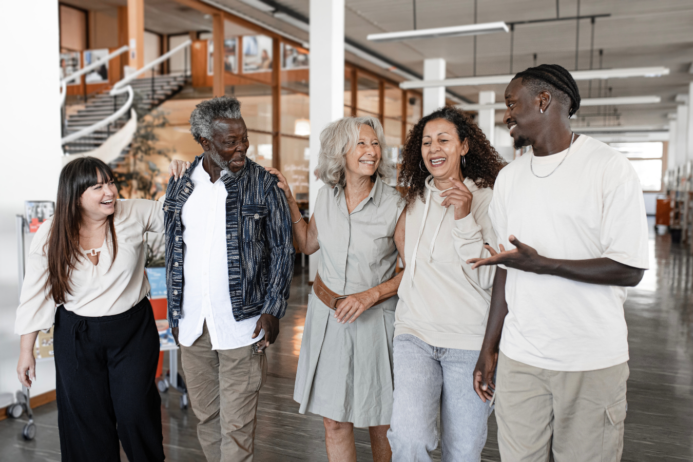 A group of adult volunteers working with a Foundation walk in a corridor. ERP software for foundations like Sparkrock 365 are all-in-one solutions tailored to nonprofits, foundations and charitable organizations.