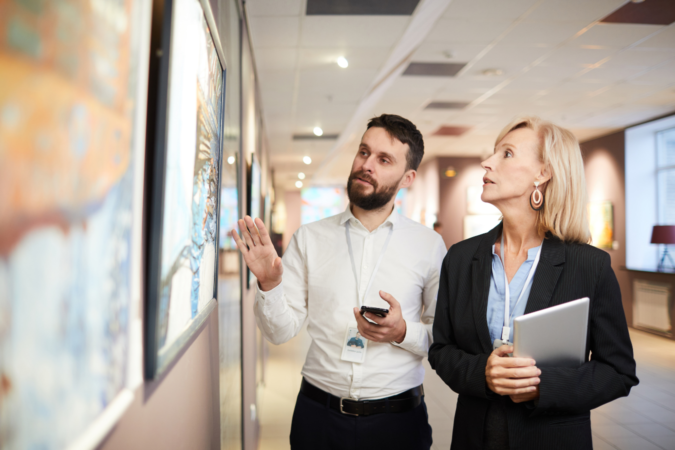 Two staff members enjoying art in a gallery. Arts and culture organizations using Sparkrock 365 ERP are more efficient, enabling them to focus on their core mission of sharing the value and beauty of the arts through education.